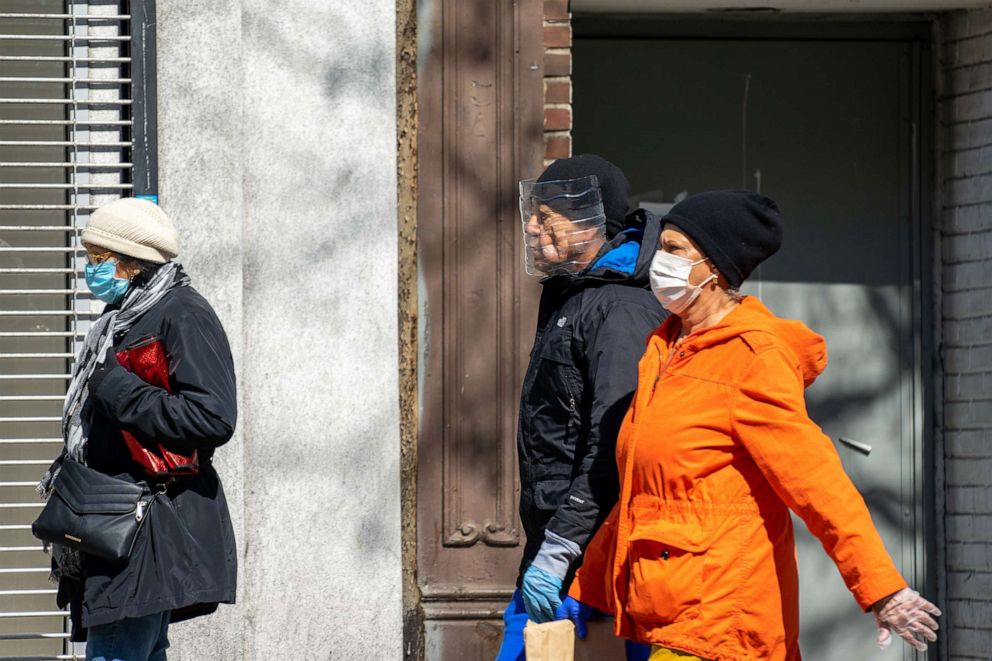 PHOTO: A person wears a homemade face shield while walking down the street on April 16, 2020, New York City.