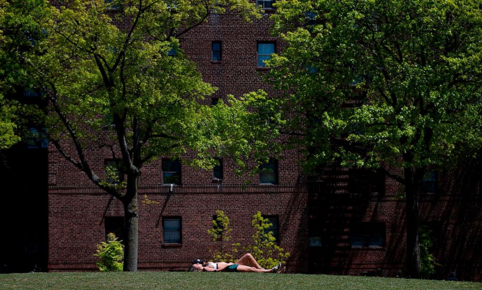 PHOTO: A couple enjoys the sun in a park in Queens on May 13, 2020 in New York City.
