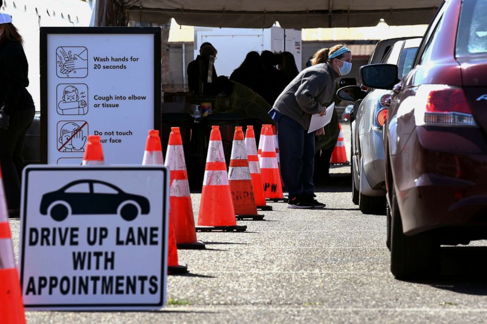 PHOTO: Residents are greeted by medical personnel as Camden County's first public coronavirus drive-thru testing site opens in Camden's Cooper's Poynt Waterfront Park in Camden, N.J., April 1, 2020.