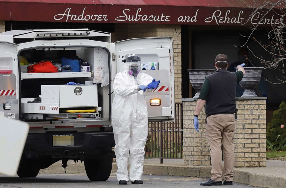 PHOTO: Paramedics and healthcare officials are seen outside Andover Subacute and Rehab Center, during the coronavirus disease outbreak, in Andover, N.J., April 16, 2020. 