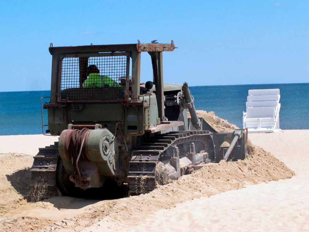 PHOTO: Workers prepare the beach in Belmar, N.J. for the summer season amid the coronavirus pandemic, May 12, 2020.