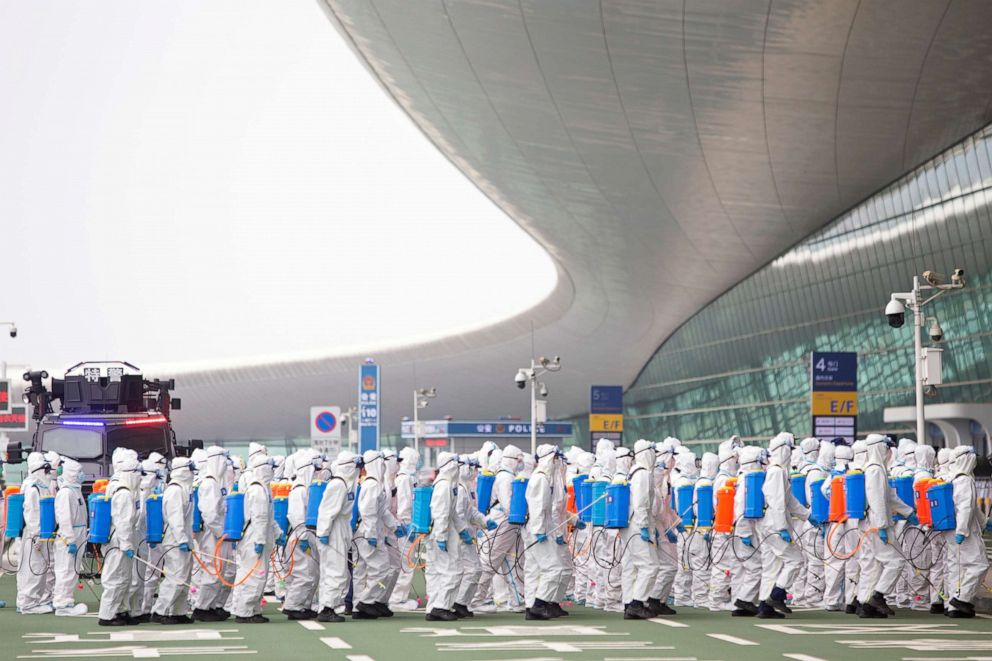 PHOTO: Firefighters in protective suits are seen during an operation to disinfect Wuhan Tianhe International Airport, April 3, 2020.