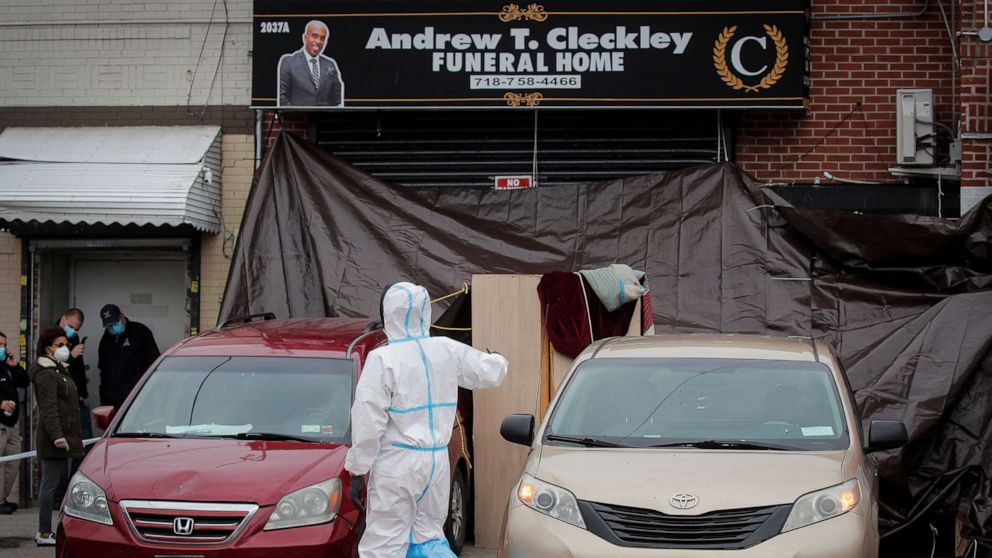 PHOTO: Workers are seen outside the Andrew T. Cleckley Funeral Services funeral home in Brooklyn, N.Y., April 30, 2020.