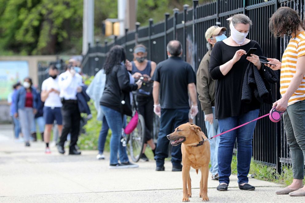 PHOTO: People stand in line for to receive a free COVID-19 test on May  4, 2020 in Jersey City, N.J.