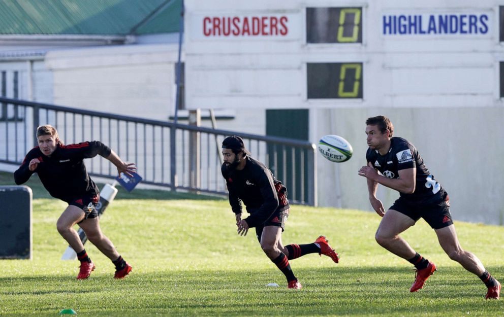 PHOTO: Crusaders players from left, Jack Goodhue, Richie Mo'unga, and George Bridge run during a training session at Rugby Park in Christchurch, New Zealand, May 27, 2020.