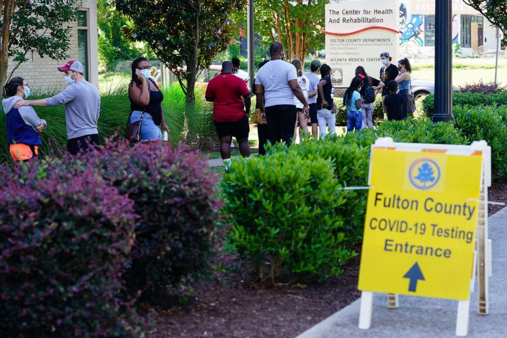 PHOTO: People stand in line to get tested for COVID-19 at a free walk-up testing site on July 11, 2020 in Atlanta.