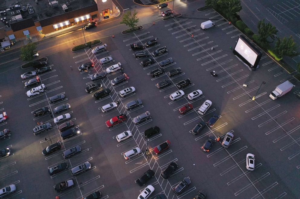 PHOTO: In an aerial view from a drone, attendees watch the movie "The Goonies" at a pop-up drive-in theatre built in the parking lot at the Broadway Commons on May 21, 2020 in Hicksville, N.Y.