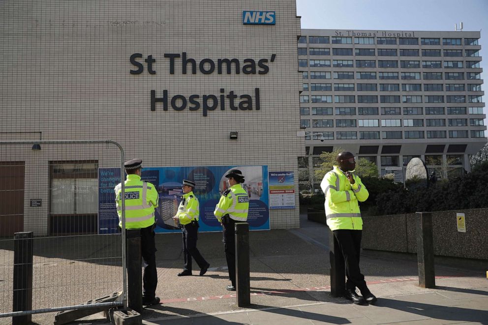 PHOTO: Three police officers at left and a security guard at right guard an entrance outside St Thomas' Hospital in London, where British Prime Minister Boris Johnson is being treated for coronavirus, April 10, 2020.