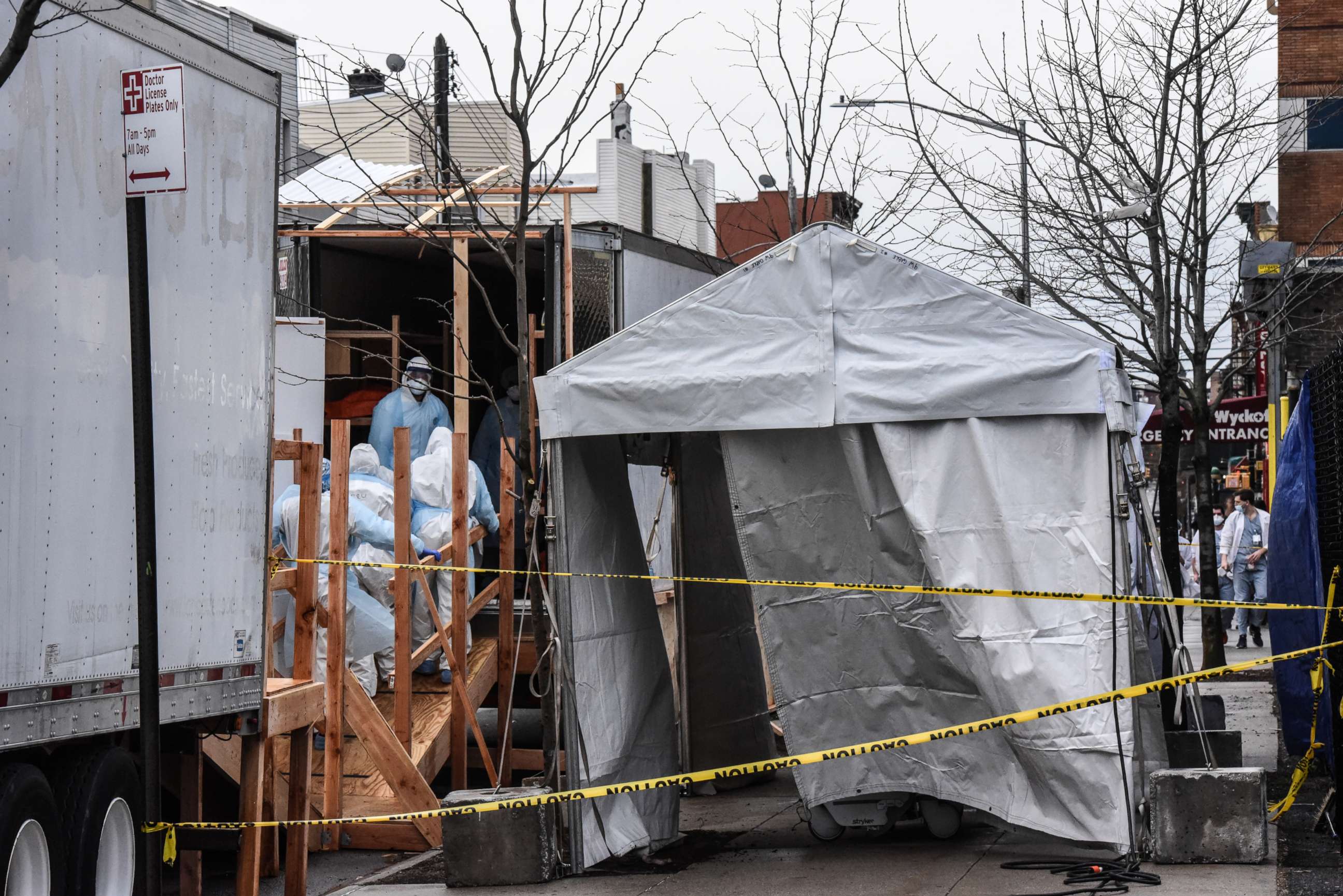 PHOTO: Medical workers are seen moving a body from the sidewalk into a refrigerator truck outside of Wyckoff Heights Medical Center in the borough of Brooklyn on April 3, 2020 in New York City.