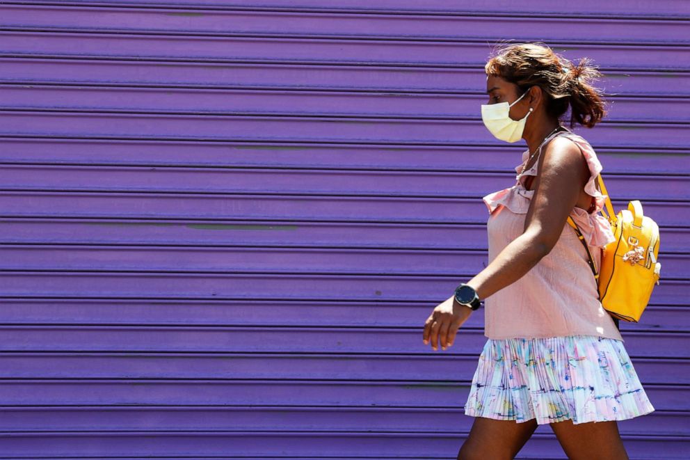 PHOTO: A woman wearing a protective face mask walks in New York, Aug. 3, 2020.