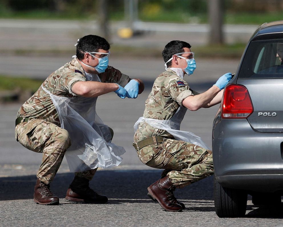 PHOTO: Military personal are seen testing people at a coronavirus test centre in the car park of Chessington World of Adventures as the spread of the coronavirus disease (COVID-19) continues, London, April 10, 2020.