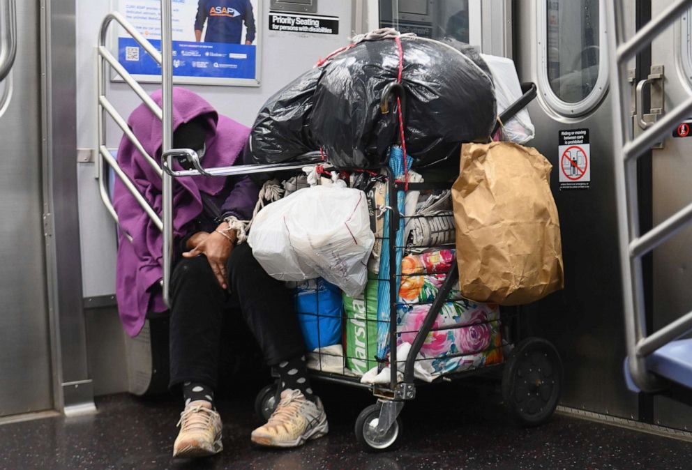 PHOTO: A homeless person sleeps in a subway train on April 29, 2020 in New York City.