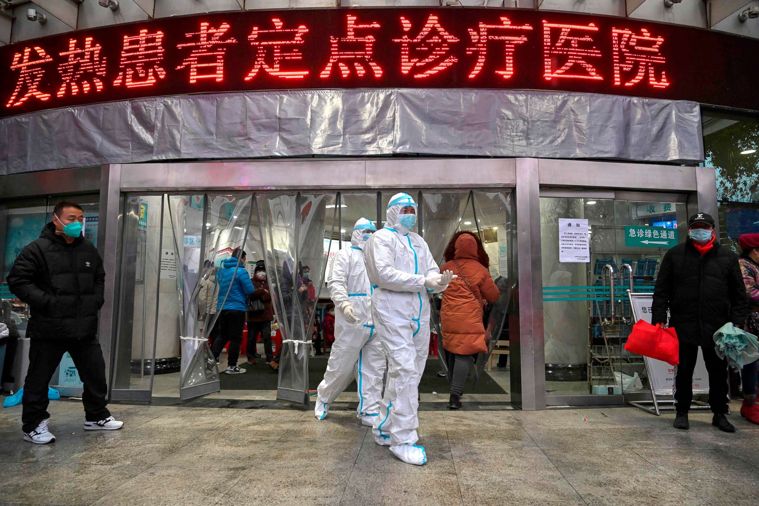 PHOTO: Medical staff members wearing protective clothing to help stop the spread of Coronavirus, which began in the city, walk at the Wuhan Red Cross Hospital in Wuhan, China, Jan. 25, 2020. 