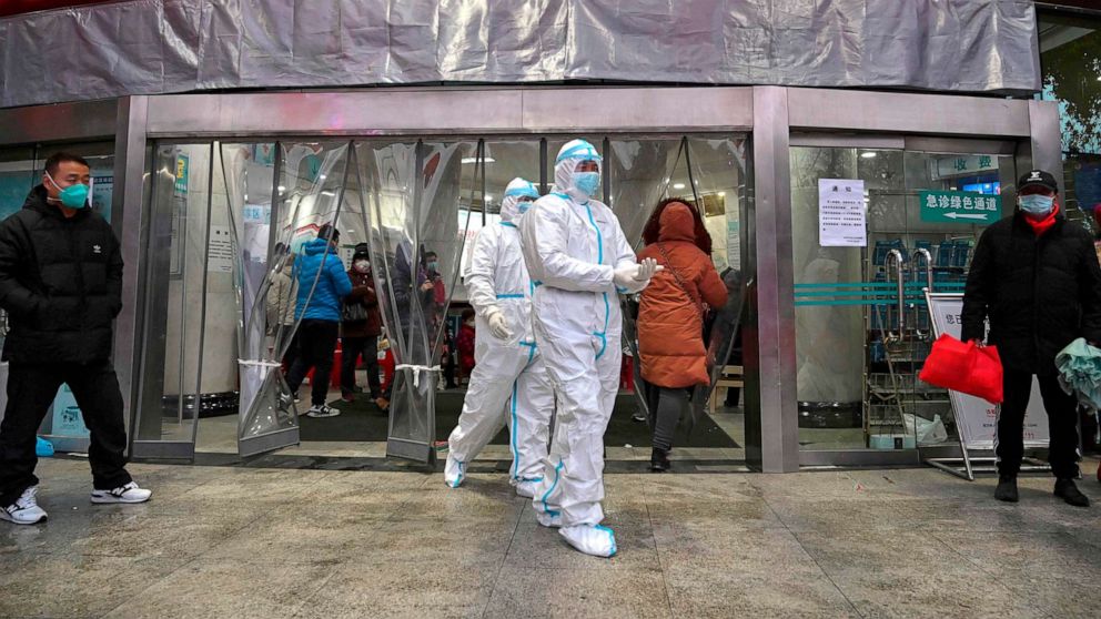 PHOTO: Medical staff members wearing protective clothing to help stop the spread of Coronavirus, which began in the city, walk at the Wuhan Red Cross Hospital in Wuhan, China, Jan. 25, 2020. 