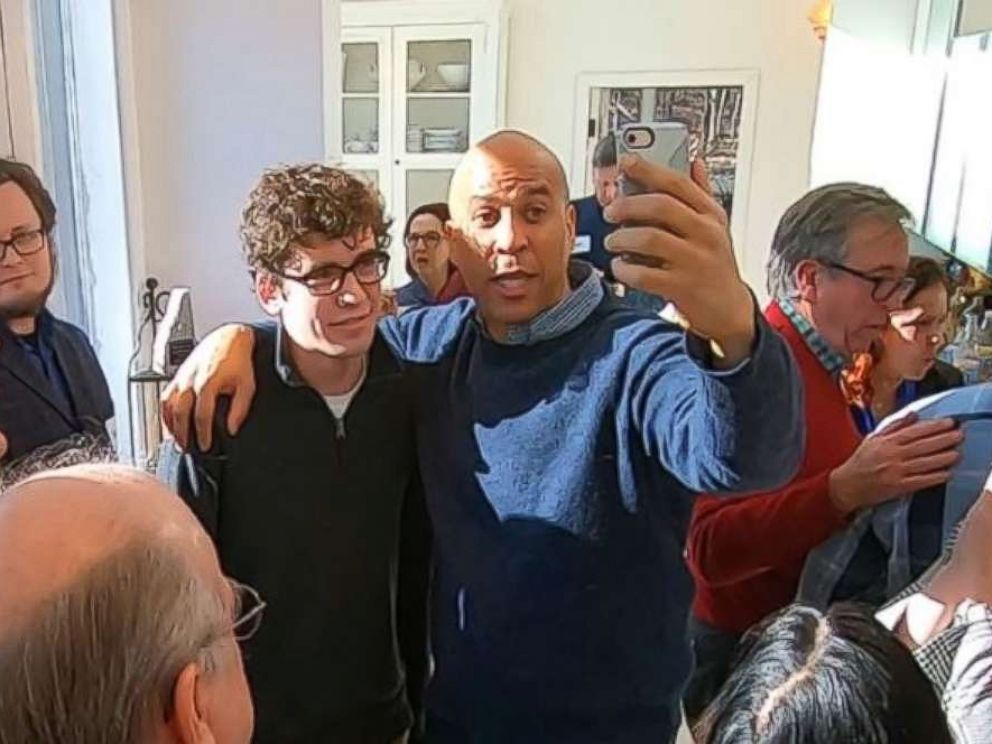   PHOTO: Senator Cory Booker, DN.J., poses for a photo at a party in Nashua, New Hampshire, while he was testing the waters for a presidential race on Saturday, December 8, 2018. 