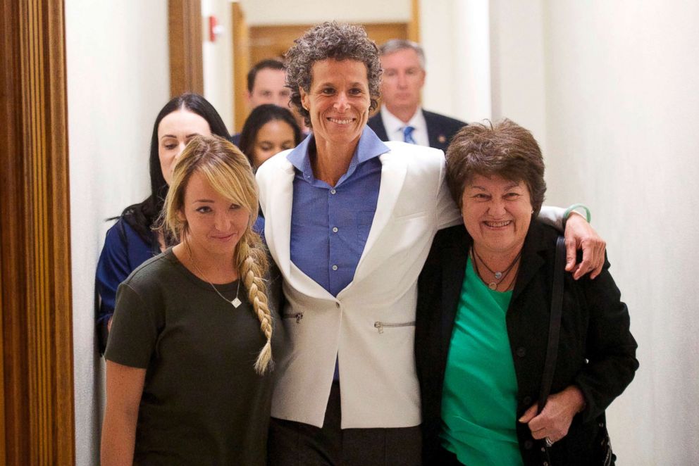 PHOTO: Bill Cosby accuser Andrea Constand, center, and supporters embrace after Cosby was found guilty in his sexual assault retrial, April, 26, 2018, at the Montgomery County Courthouse in Norristown, Pa.