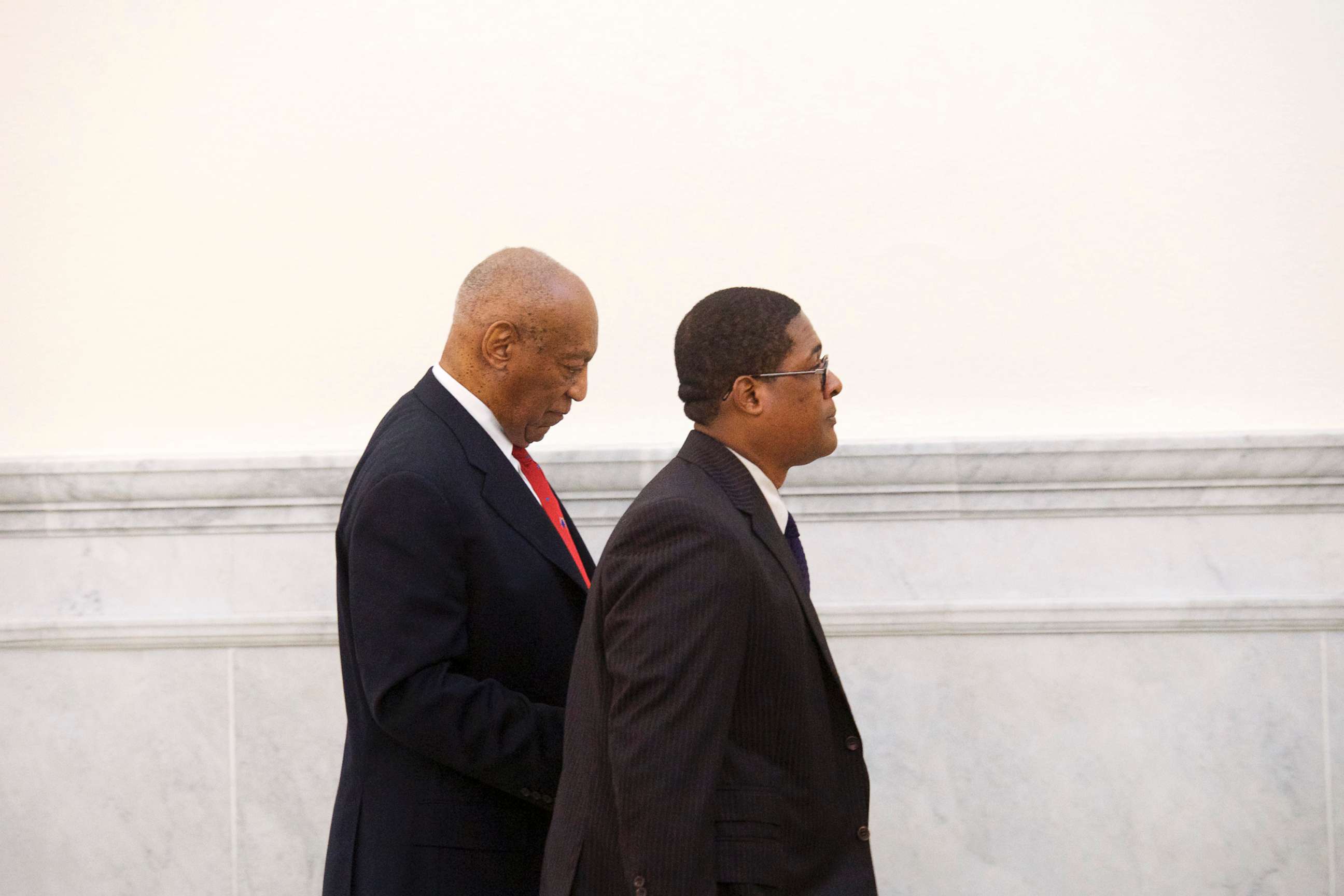 PHOTO: Bill Cosby walks through the Montgomery County Courthouse with his publicist, Andrew Wyatt, after being found guilty on all counts in his sexual assault retrial, April 26, 2018, in Norristown, Pa.