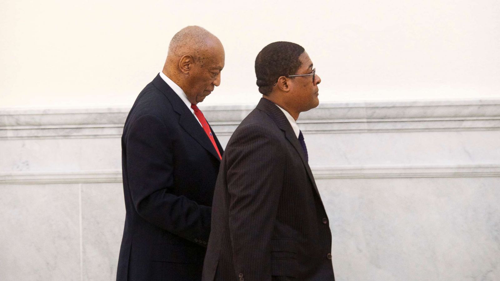 PHOTO: Bill Cosby walks through the Montgomery County Courthouse with his publicist, Andrew Wyatt, after being found guilty on all counts in his sexual assault retrial, April 26, 2018, in Norristown, Pa.