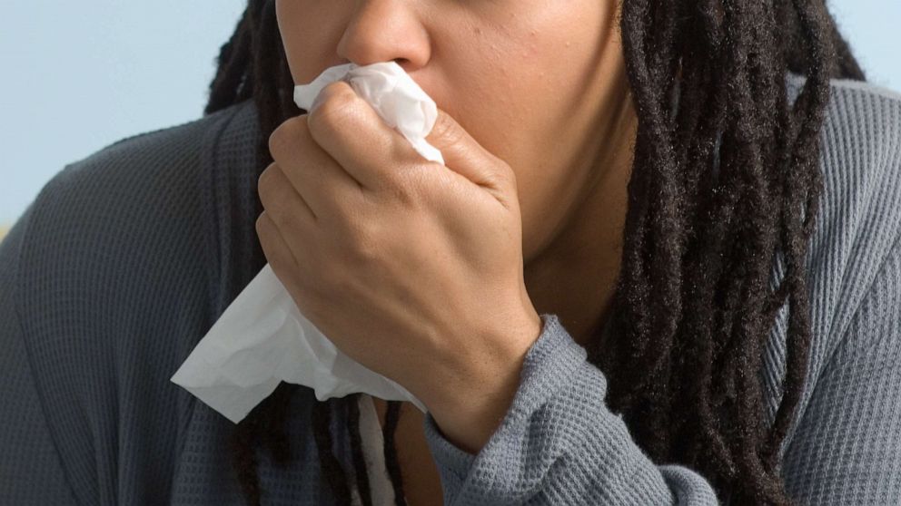 PHOTO: A woman coughs into a tissue in an undated stock photo. 