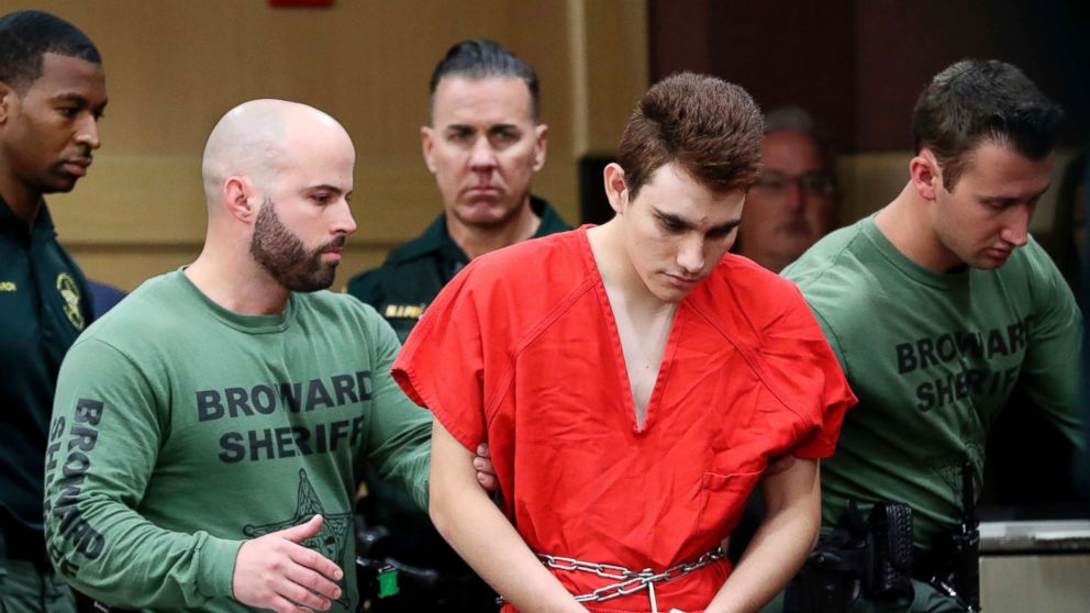 Nikolas Cruz is lead into the courtroom before being arraigned at the Broward County Courthouse in  Fort Lauderdale, Fla., March 14, 2018.