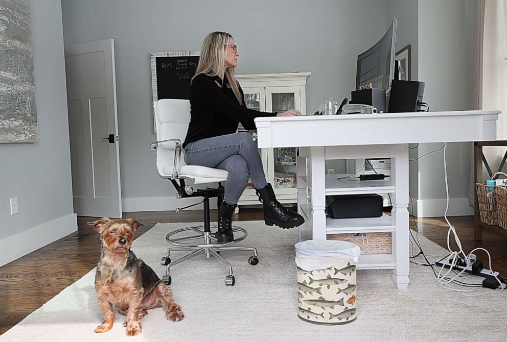 PHOTO: Jessica Weadock in her home office with her only in person colleague, her dog named Rocky, in Bolton, Mass., Feb. 23, 2021.