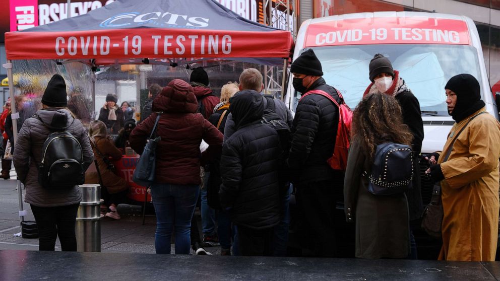 PHOTO: People wait in line to get tested for COVID-19 at a testing facility in Times Square, Dec. 9, 2021, in New York.