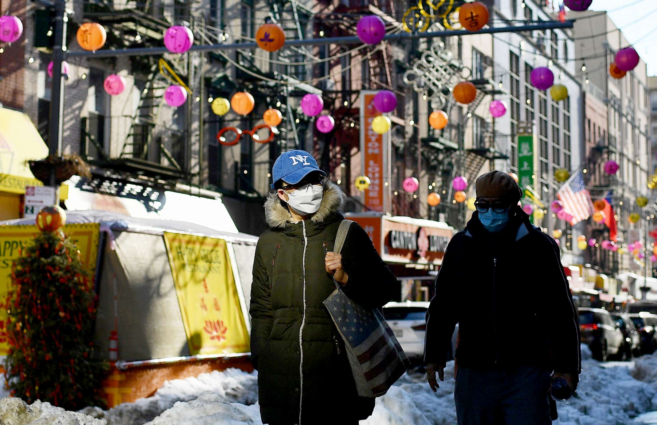 PHOTO: People wearing facemasks walk in the Chinatown area of New York City, Feb. 5, 2021. 
