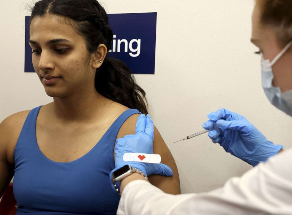 PHOTO: In this Oct. 13, 2022, file photo, a woman receives a bivalent COVID-19 booster from a pharmacist at a CVS store in Chicago.