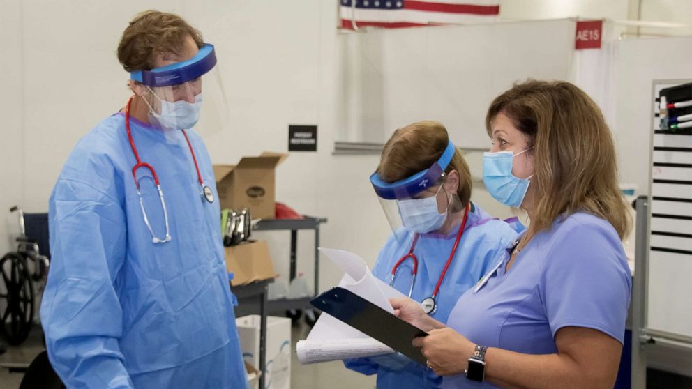 PHOTO: Medical personnel work inside a field hospital known as an alternate care facility at the state fair ground near Milwaukee, Wisconsin, on Oct. 12, 2020, as COVID-19 cases spike in the state.