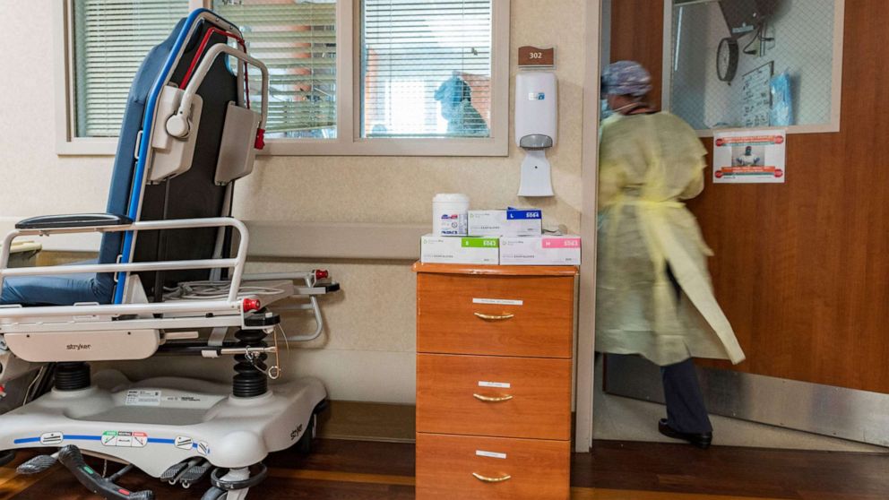 PHOTO: A nurse enters a Covid-19 patient's room inside the ICU (intensive care unit) at Adventist Health in Sonora, Calif., Aug. 27, 2021.