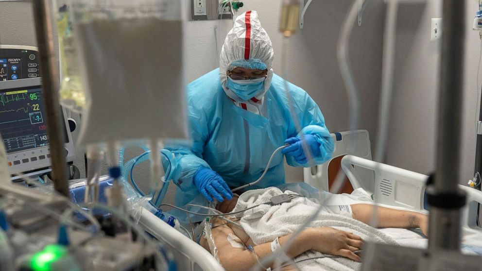 PHOTO: Susan Paradela sorts wires and tubes connected to a patient in the COVID-19 ICU at the United Memorial Medical Center on Dec. 7, 2020, in Houston. Texas has exceeded more than 1.35 million cases of Covid-19, with more than 23,200 deaths. 