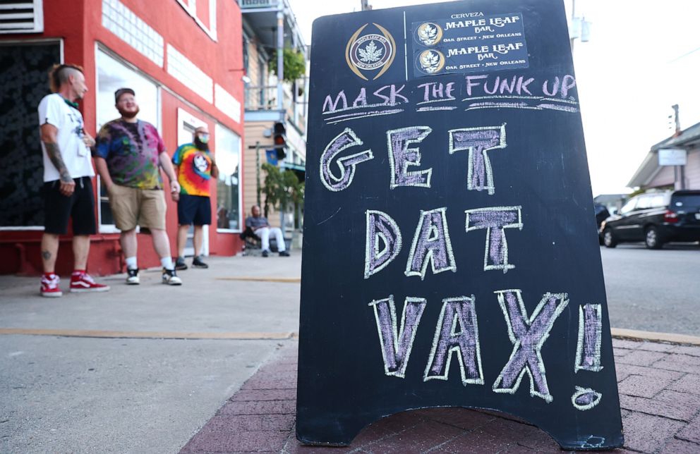 PHOTO: A sign reads 'Get Dat Vax!' in front of a popup vaccination clinic at Maple Leaf Bar in  New Orleans, La., Aug. 14, 2021.