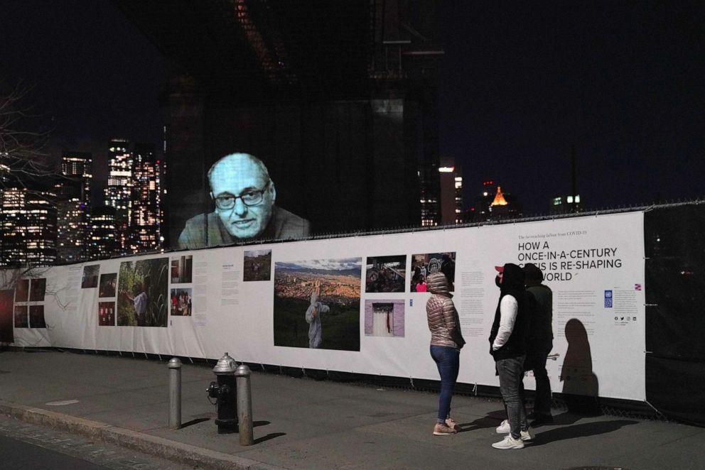 PHOTO: Projections are seen on the Brooklyn Bridge, as part of "A COVID-19 Day of Remembrance" dedicated to the New Yorkers lost during the coronavirus disease (COVID-19) pandemic, in New York City, U.S. March 14, 2021.