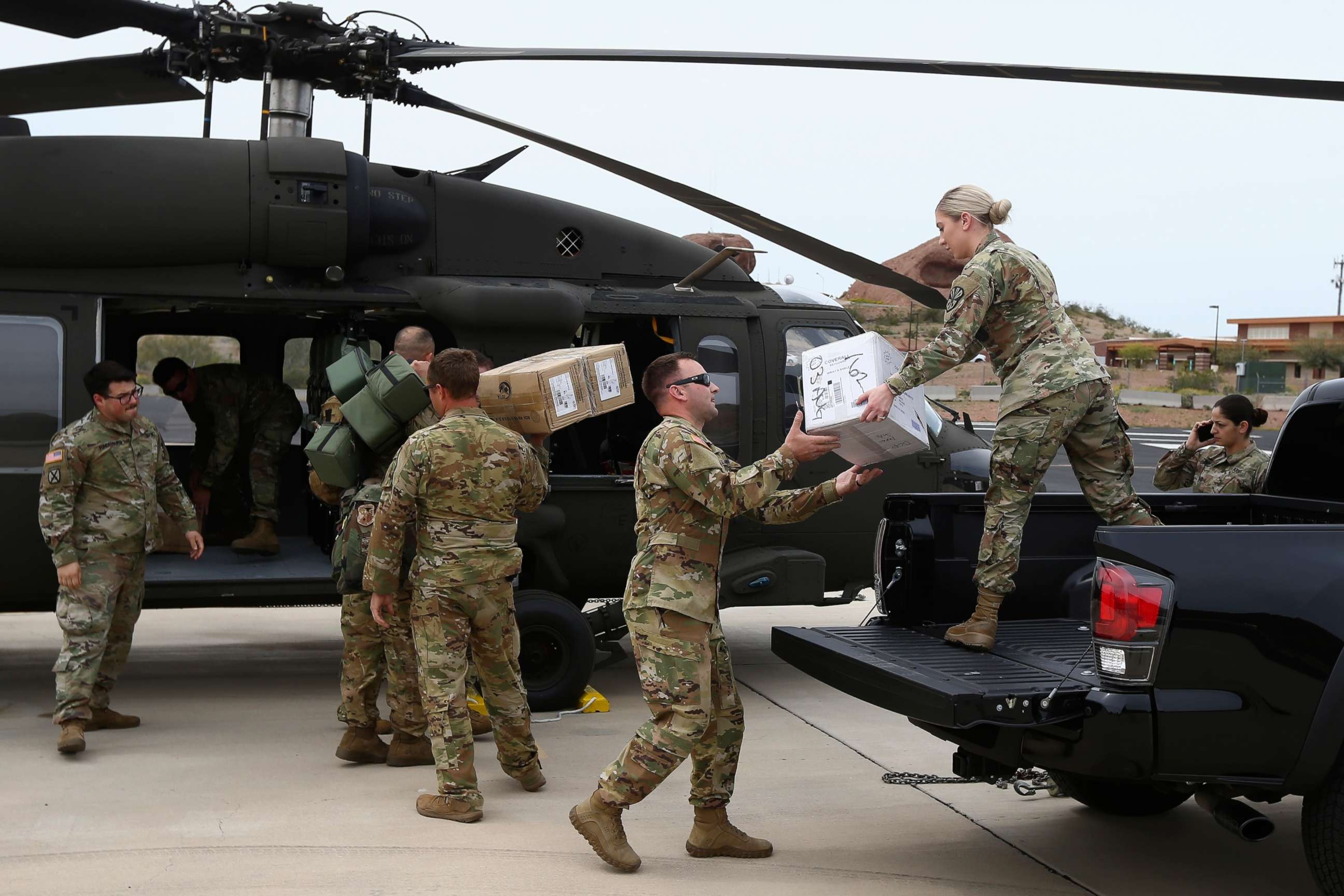 PHOTO: Members of a Arizona National Guard unit load up a Black Hawk helicopter to deliver medical supplies to the remote Navajo Nation town of Kayenta due to the coronavirus, March 31, 2020, in Phoenix. 