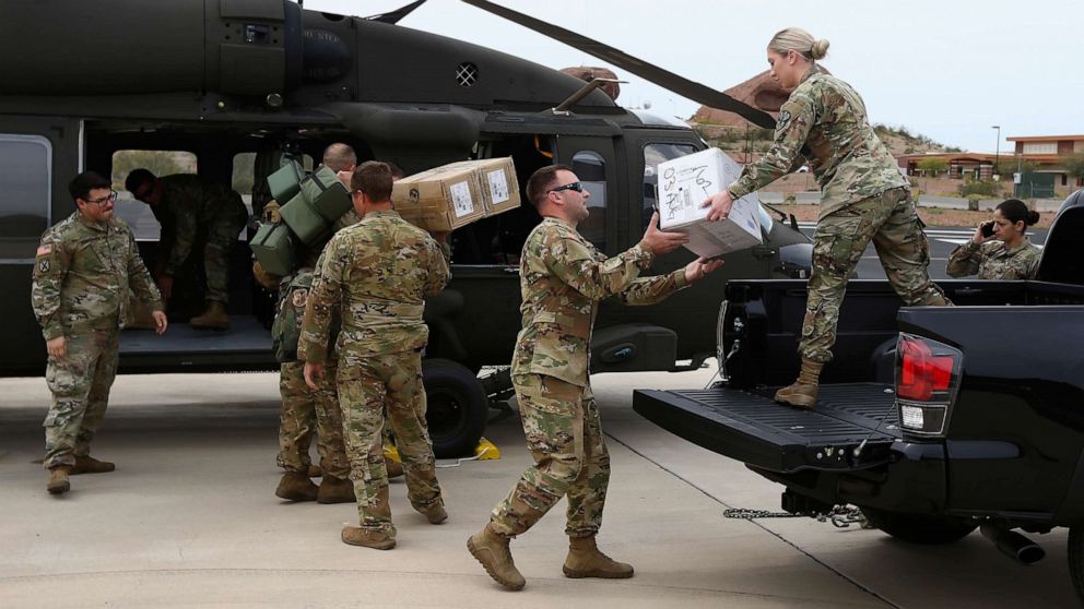PHOTO: Members of a Arizona National Guard unit load up a Black Hawk helicopter to deliver medical supplies to the remote Navajo Nation town of Kayenta due to the coronavirus, March 31, 2020, in Phoenix. 