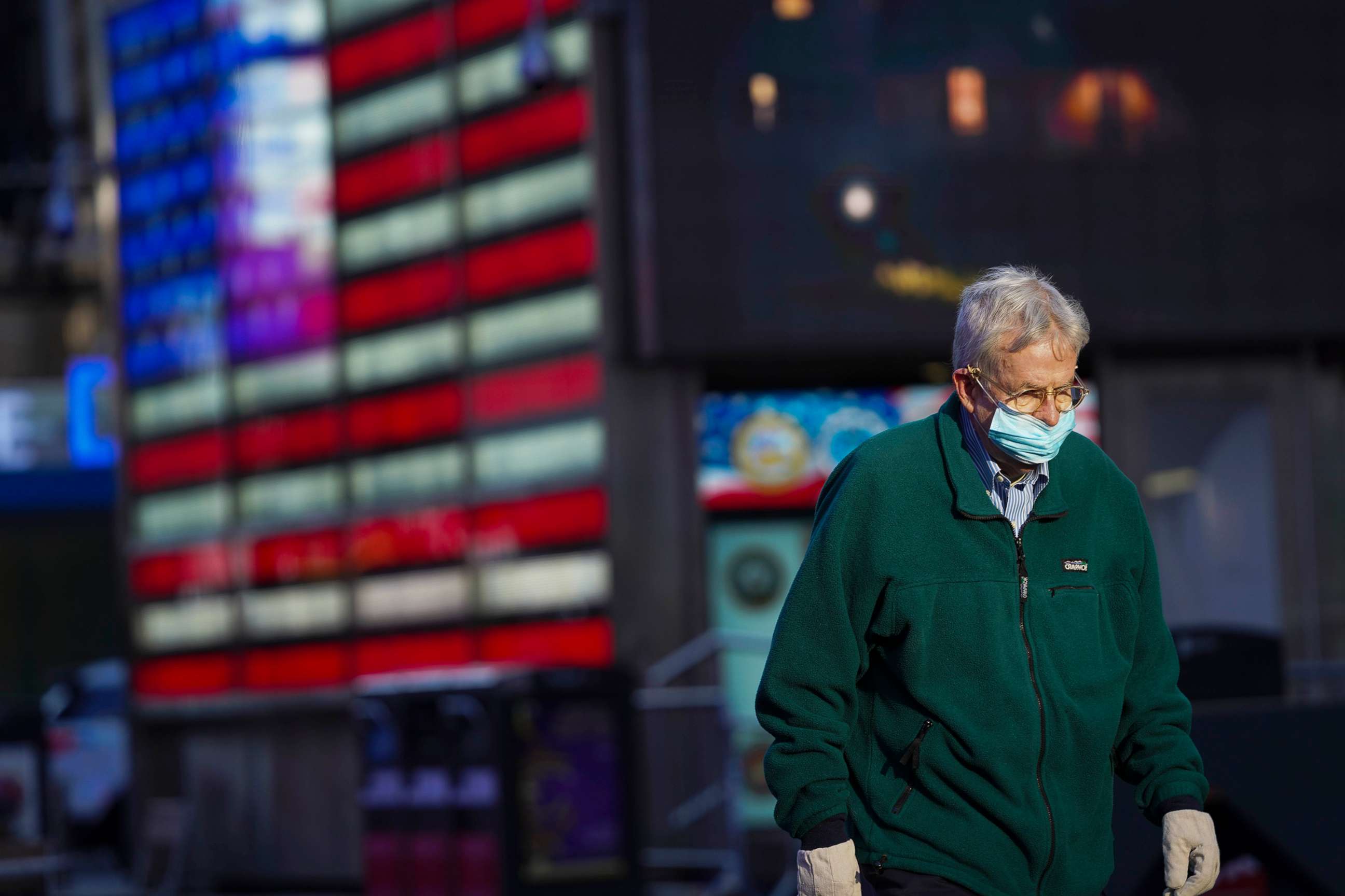 PHOTO: A man wears a face mask while walking in Times Square in New York, Nov. 18, 2020.