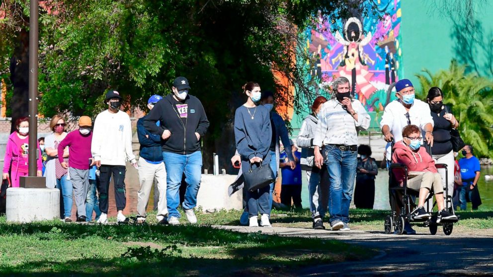 PHOTO: People wait in a long line for Covid-19 vaccinations at Lincoln Park in Los Angeles, Calif., on Feb. 23, 2021. 
