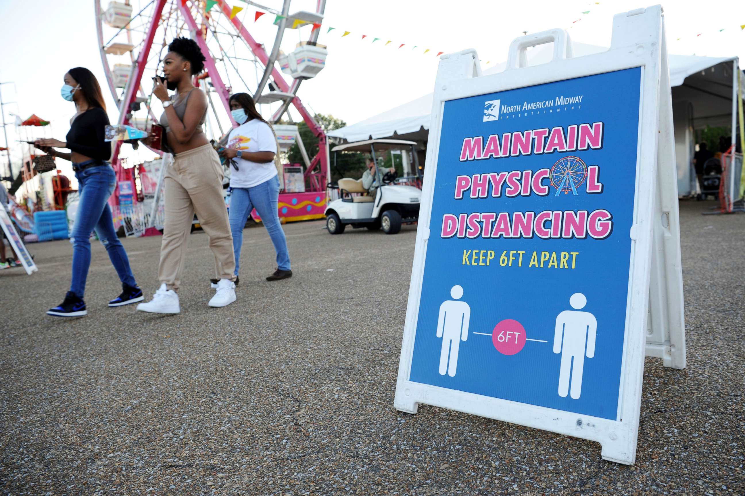 PHOTO: Signage reminds attendees to practice social distancing at the entrance of the Mississippi State Fair as it opens with coronavirus restrictions in Jackson, Miss., Oct. 7, 2020.