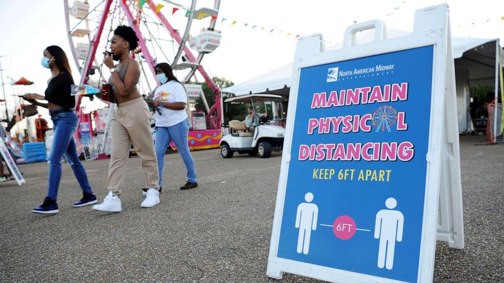 PHOTO: Signage reminds attendees to practice social distancing at the entrance of the Mississippi State Fair as it opens with coronavirus restrictions in Jackson, Miss., Oct. 7, 2020.