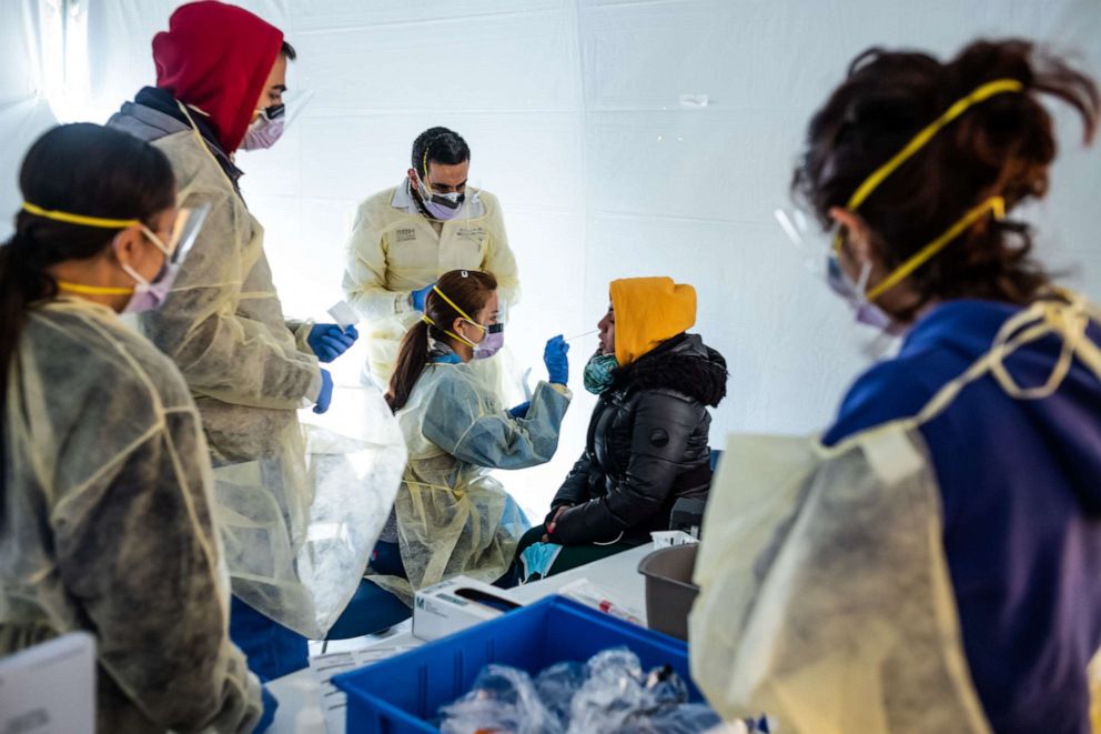 PHOTO: Doctors test hospital staff with flu-like symptoms for coronavirus (COVID-19) in set-up tents to triage possible COVID-19 patients outside before they enter the main Emergency department area at St. Barnabas hospital, March 24, 2020 in New York.