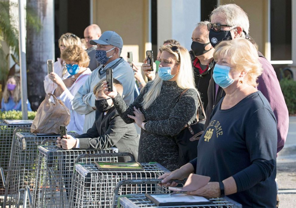 PHOTO: People listen as Gov. Ron DeSantis announces outside a Publix supermarket in Jupiter, Fla., on Jan. 19, 2021, that vaccinations against Covid-19 are coming to all all 67 Publix pharmacies in Palm Beach County.