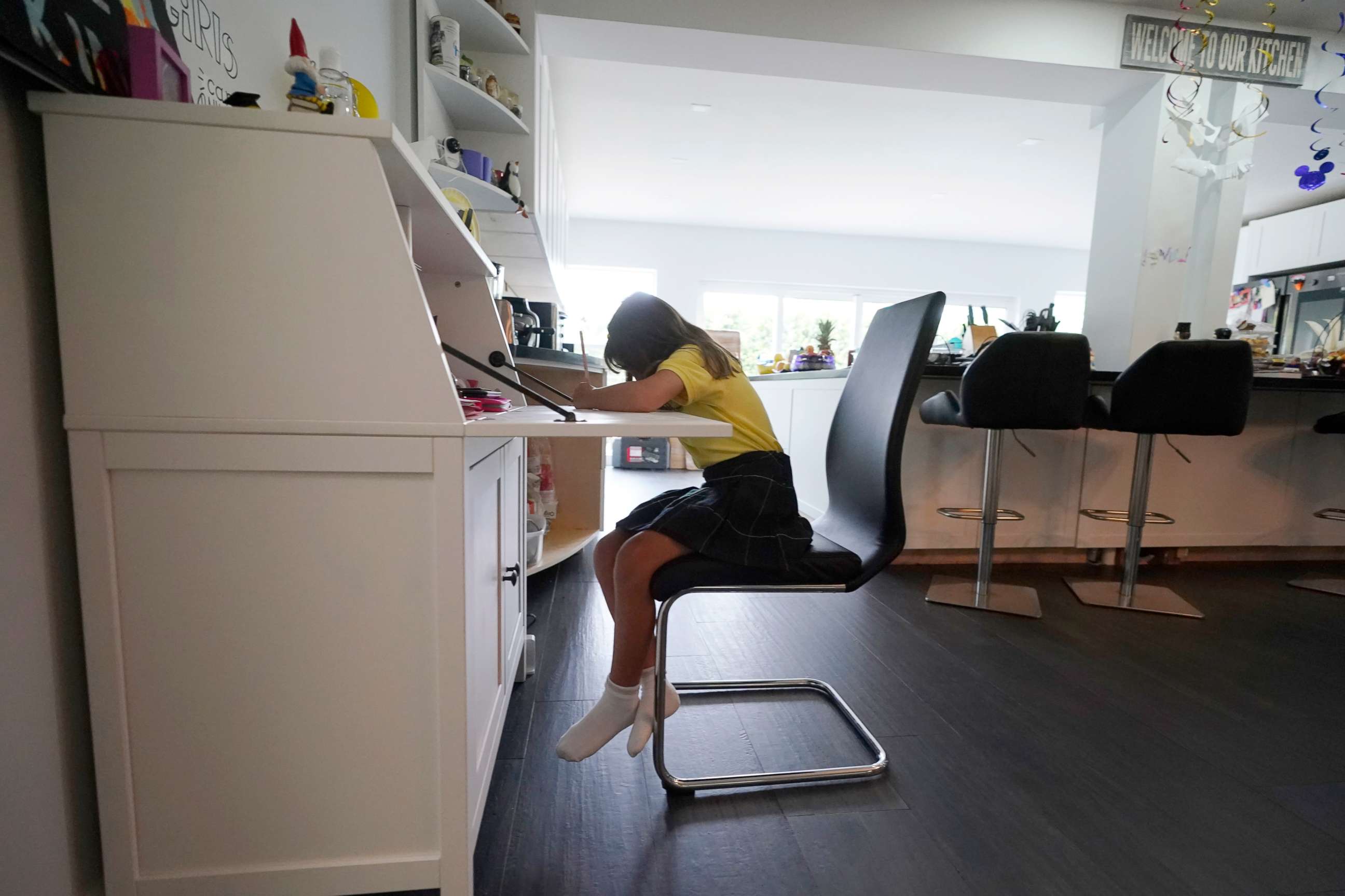 PHOTO: A student works on a writing exercise from remote learning at her home in North Miami Beach, Fla. Oct. 1, 2020.