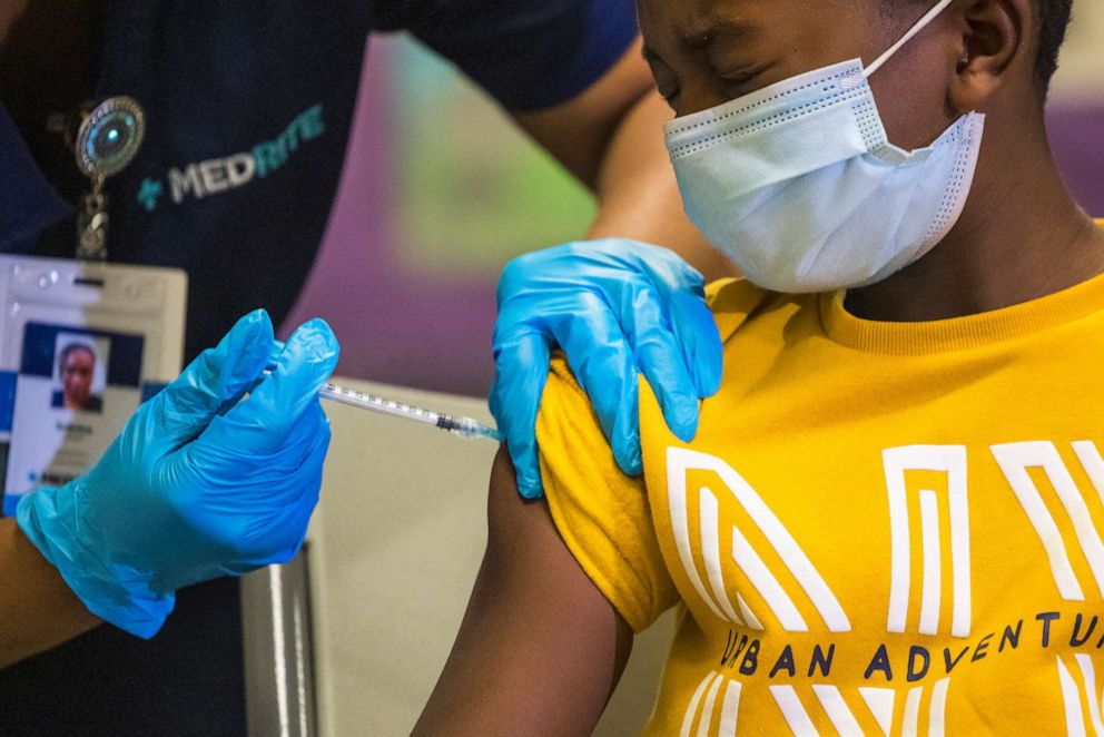 PHOTO: Tse Cowan, 8, winces as he is administered the Pfizer COVID-19 vaccine at a pop-up vaccine site at P.S. 19 on Nov. 08, 2021 in the Lower East Side of New York City.