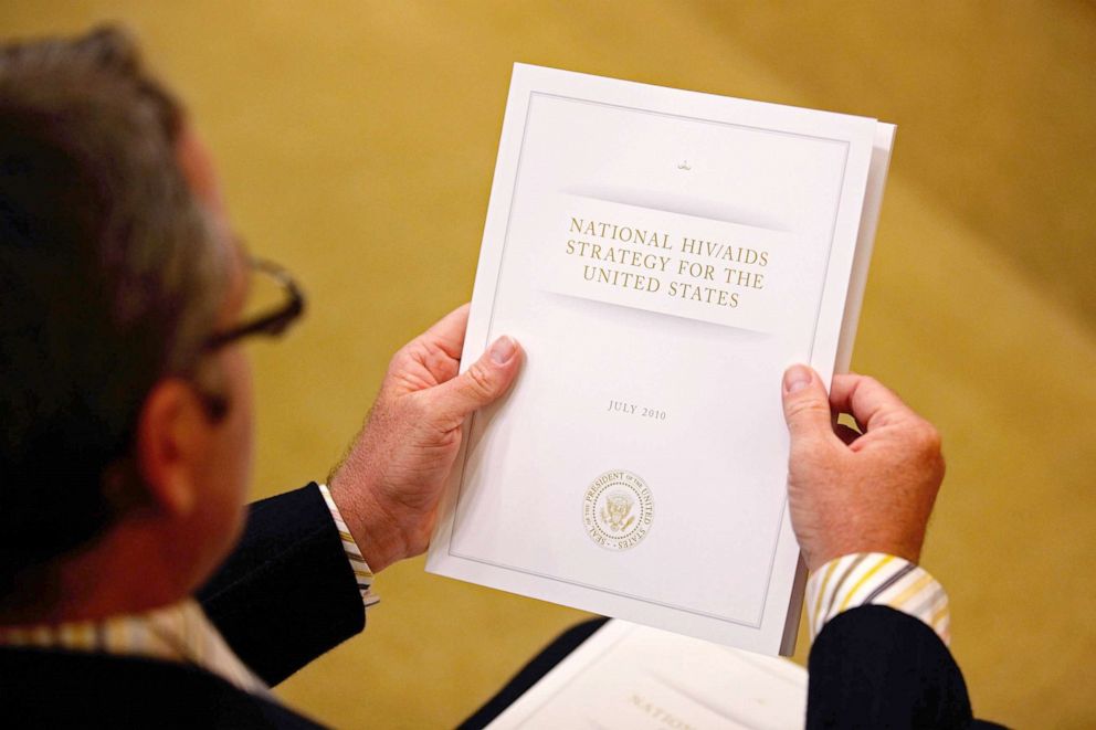 PHOTO: A copy of the National HIV/AIDS Strategy (NHAS) is held by a member of the audience during its introduction by President Barak Obama in Washington, July 13, 2010 