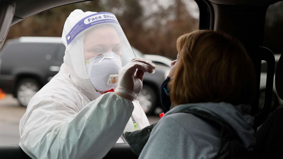 PHOTO: Aneda Fowler, a volunteer healthcare worker from Columbus, tests a person at a COVID-19 pop-up testing site sponsored by a health care group, Dec. 30, 2021, in Columbus, Ohio.