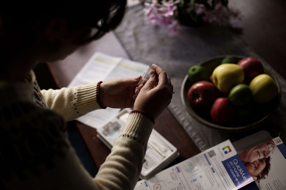 PHOTO: A person prepares to take a self-administered at-home Covid-19 test, received through a government program, in Easton, N.H., Dec. 7, 2021.