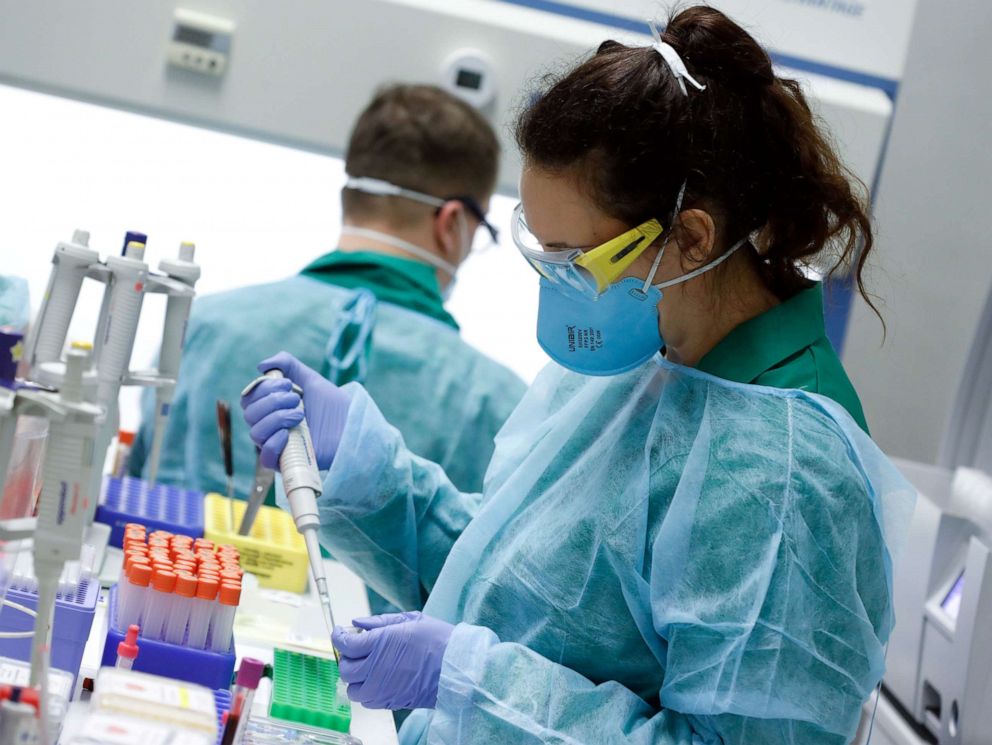 PHOTO: Employees in protective clothing carry out tests for the coronavirus at a laboratory in Berlin, March 26, 2020. 