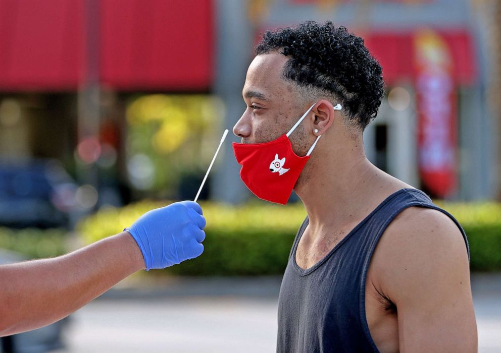 PHOTO: Davon Lewin receives a COVID-19 test from EMT Christopher Linares at a Blue Med Consultants facility on Sept. 9, 2021 in North Miami. 