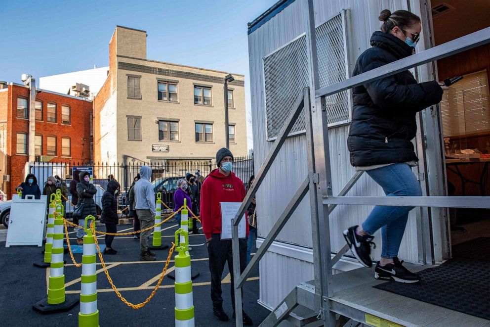 PHOTO: People line up to get tested for Covid-19 at East Boston Neighborhood Health Center in Boston, Massachusetts, Dec. 20, 2021.