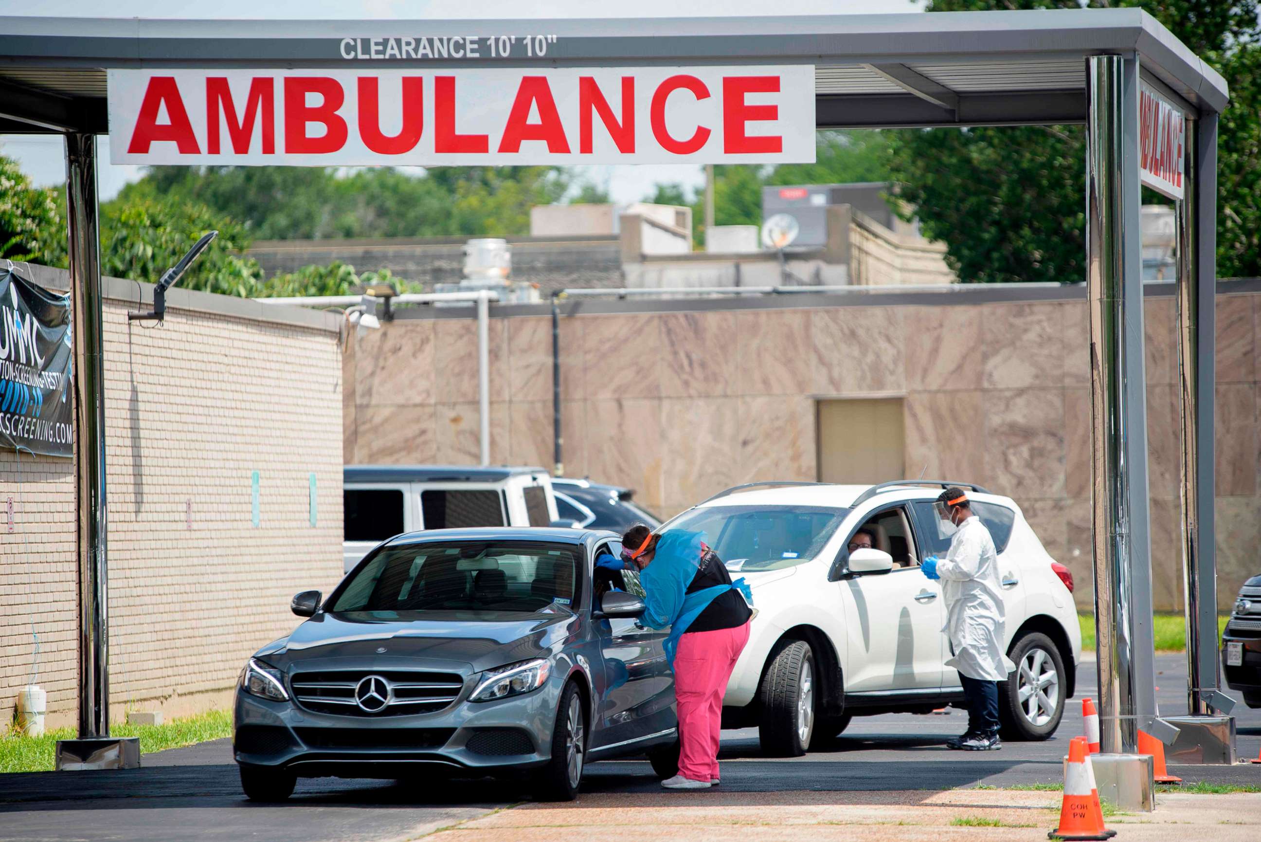 PHOTO: Healthcare workers administer tests at a COVID-19 testing site at United Memorial Medical Center in Houston, on July 9, 2020.